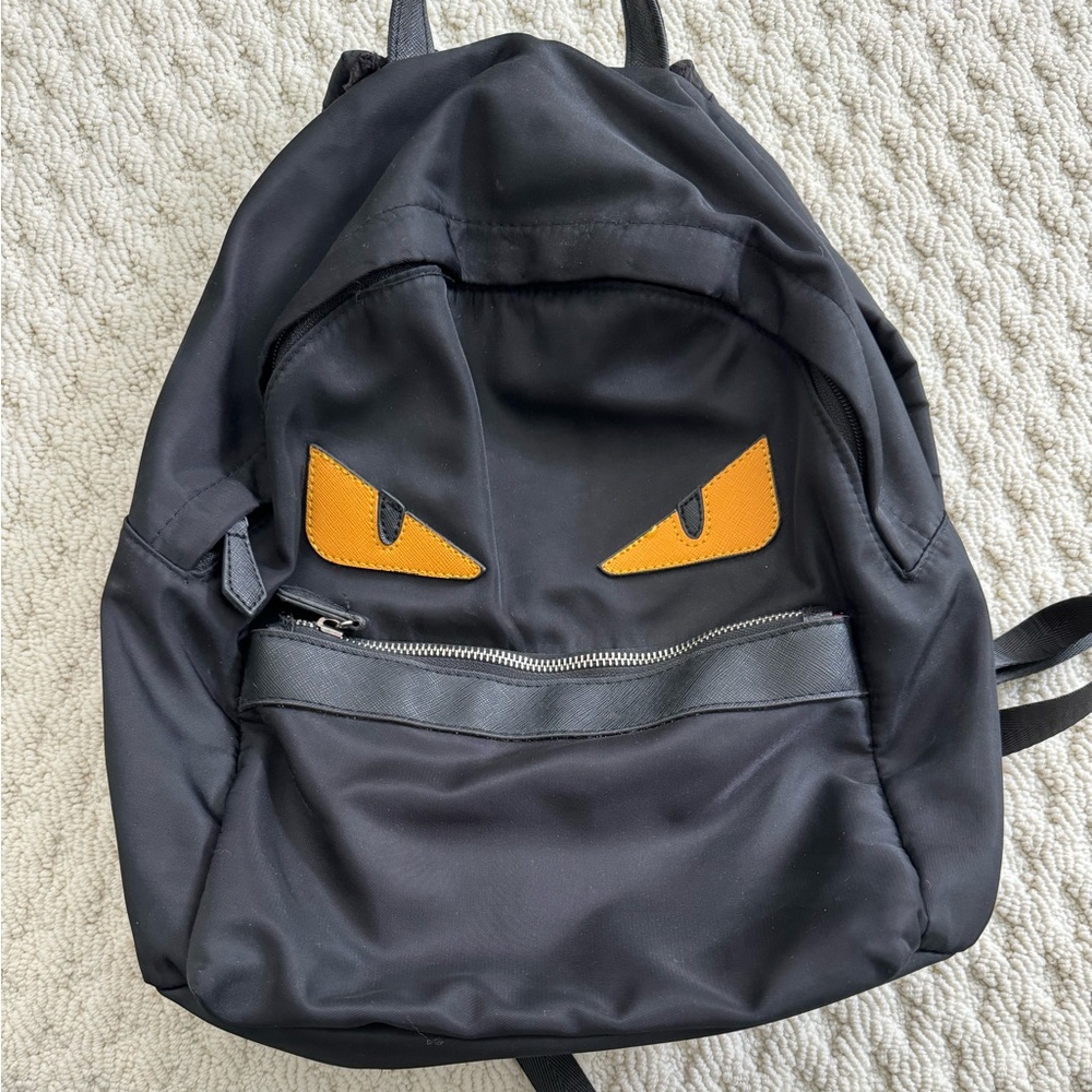 Black nylon bag with yellow eyes face